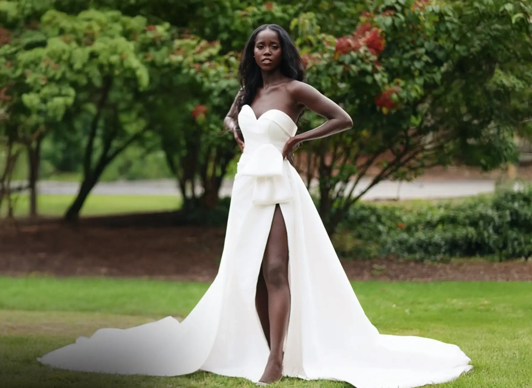 Model wearing a white gown by Andrea Osei